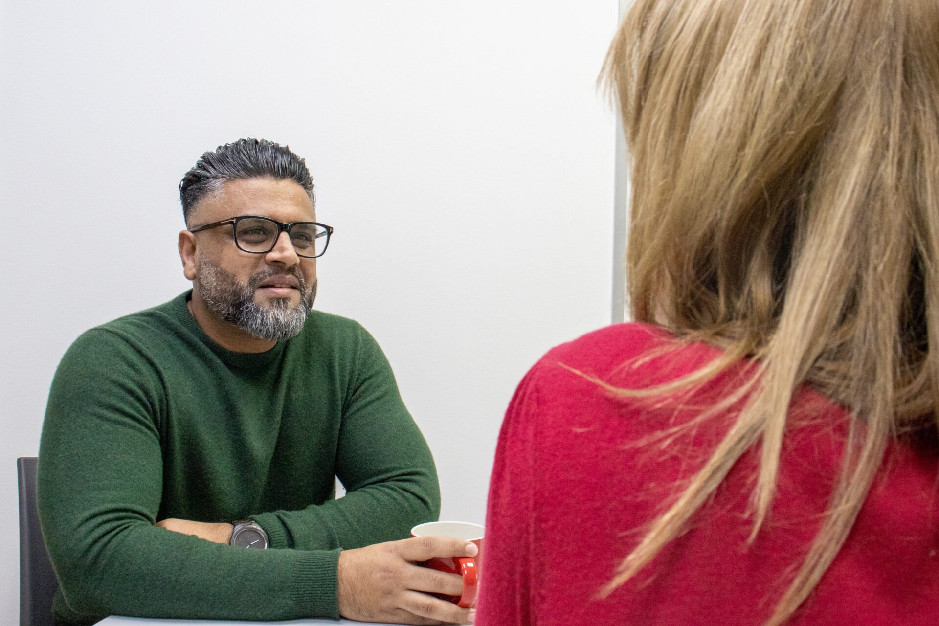 Adeel Azam, speaking with a female colleague in the Perform Partners' head office