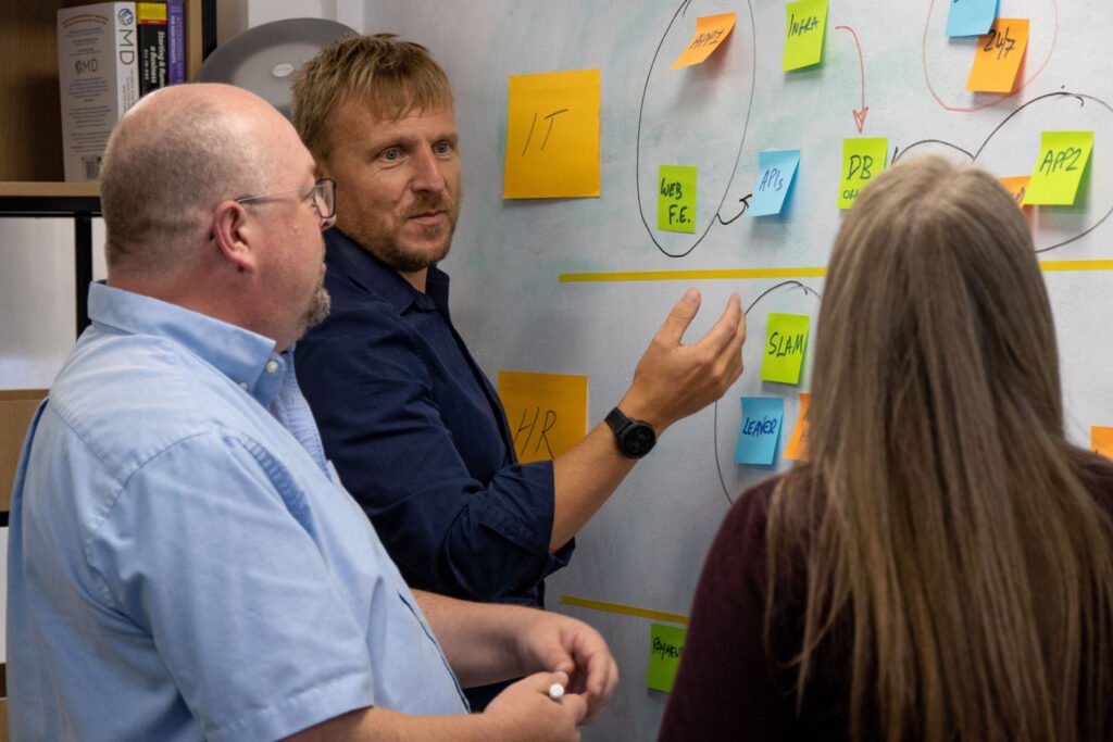 Mark Perrell employee spotlight captured near a white board 